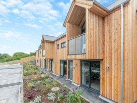 An outdoor view of a modern wooden building at Gwari Spa Barn 2.0 in Marhamchurch