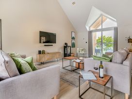 A living room with a sofa and coffee table at Gwari Spa Barn 2.0 Marhamchurch