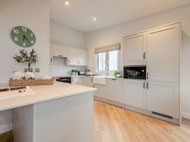 A kitchen with a sink and microwave at Trelowen 2.0 Spa in Marhamchurch