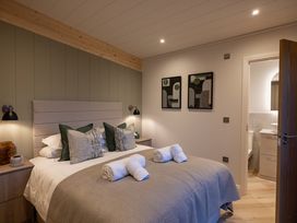 A bedroom with a bed and artwork at Trelowen 2.0 Spa in Marhamchurch