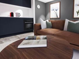 A living room with a sofa and coffee table at Arvor Duplex 2.0 Marhamchurch