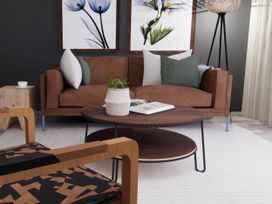 A living room with a sofa and coffee table at Arvor Duplex 2.0 in Marhamchurch