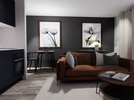 A living room with a sofa and coffee table at Arvor Duplex 2.0 in Marhamchurch