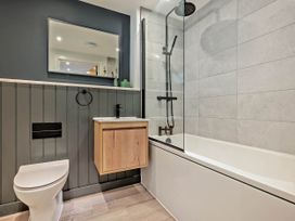 A bathroom with a bathtub and standing shower at Arvor Duplex 2.0 in Marhamchurch