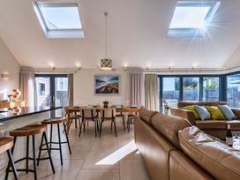 A living room with a sofa and dining table at Nettlecoombe Spa in Marhamchurch