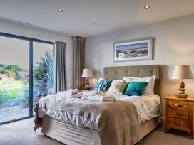 A bedroom with a bed and nightstand at Nettlecoombe Spa in Marhamchurch