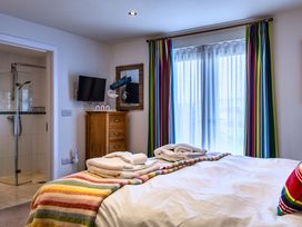 A bedroom with a bed and television at Nettlecoombe Spa Marhamchurch