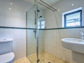 A bathroom with a shower, toilet, and sink at Nettlecoombe Spa in Marhamchurch