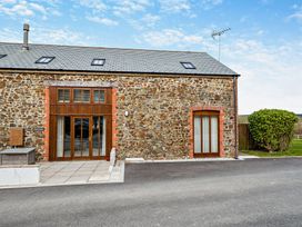 A stone building with windows and doors at Jack's House in Marhamchurch