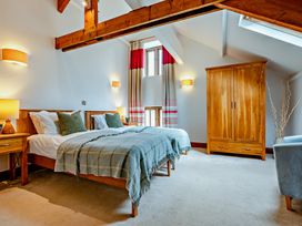 A bedroom with two beds and a wardrobe at Jack's House in Marhamchurch