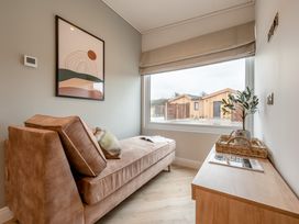 A living room with a sofa and window at Trelowen 4.0 Spa in Marhamchurch