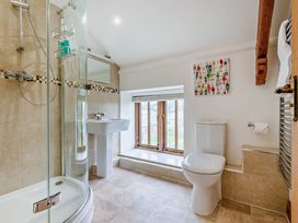 A bathroom with a shower, sink and toilet at Trelowen 4.0 Spa Marhamchurch