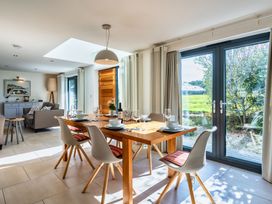 A dining room with a table and chairs at Arundell in Marhamchurch