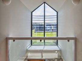 A staircase with a window and handrail at Arundell in Marhamchurch