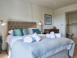 A bedroom with a bed and towels on the bed at Eagle's Nest in Marhamchurch