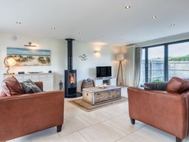 A living room with a fireplace and sofa at Moleyns in Marhamchurch