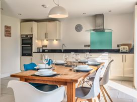 A kitchen with a dining table and chairs at Moleyns in Marhamchurch