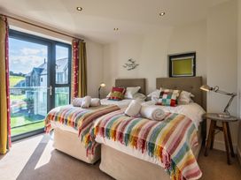 A bedroom with two beds and a view of the outdoors at Moleyns in Marhamchurch