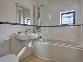 A bathroom with toilet, sink, shower, and bathtub at Moleyns in Marhamchurch