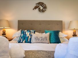 A bedroom with a bed and pillows at Moleyns in Marhamchurch