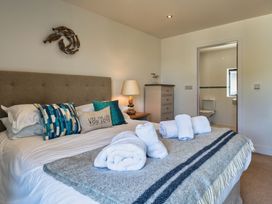 A bedroom with a bed and pillows at Moleyns in Marhamchurch