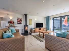 A living room with a fireplace and television at Sheep's House in Marhamchurch