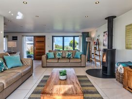 A living room with a fireplace and sofas at Sheep's House in Marhamchurch