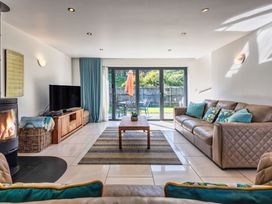 A living room with a sofa, coffee table and television at Sheep's House in Marhamchurch