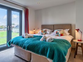 A bedroom with a bed and window at Sheep's House in Marhamchurch