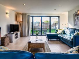 A living room with a sofa and coffee table at Trevelyan in Marhamchurch