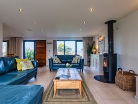 A living room with sofas and a coffee table at Trevelyan in Marhamchurch