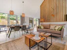 A living room with a sofa and dining table at Gwari Spa Barn 3.0 in Marhamchurch