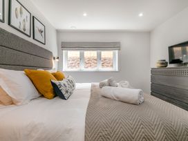 A bedroom with a bed and nightstand at Gwari Spa Barn 3.0 Marhamchurch