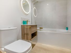 A bathroom with sink and bathtub at Gwari Spa Barn 3.0 in Marhamchurch