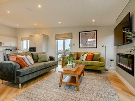 A living room with sofas and a coffee table at Trelowen 3.0 Spa in Marhamchurch