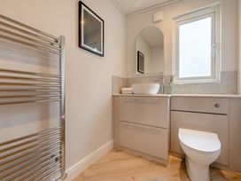 A bathroom with a sink and toilet at Trelowen 3.0 Spa in Marhamchurch