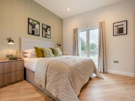 A bedroom with a bed and window at Trelowen 3.0 Spa in Marhamchurch