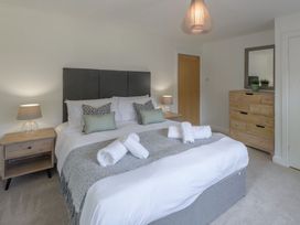 A bedroom with a bed and nightstands at Windy Hills Spa in Marhamchurch