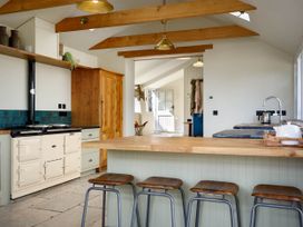 A kitchen with a stove and countertop at Whalesborough Farmhouse Spa Marhamchurch