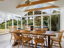 A dining area with a table and chairs at Whalesborough Farmhouse Spa Marhamchurch