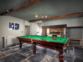 A game room with a pool table and bar area at Whalesborough Farmhouse Spa in Marhamchurch