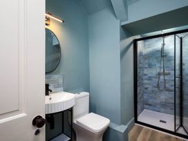 A bathroom featuring a shower, toilet, and sink at Whalesborough Farmhouse Spa, Marhamchurch