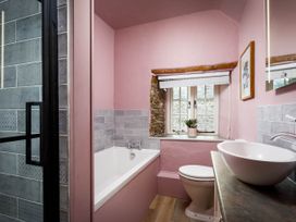 A bathroom with a bathtub, toilet, and sink at Whalesborough Farmhouse Spa in Marhamchurch