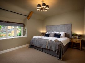 A bedroom with a bed and a window at Whalesborough Farmhouse Spa Marhamchurch