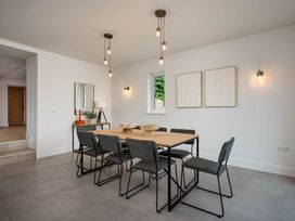 A dining room with a table and chairs at Whalesborough Cottage Spa Marhamchurch