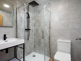 A bathroom with shower, toilet, and sink at Whalesborough Cottage Spa in Marhamchurch