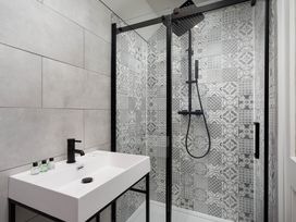 A bathroom with shower and sink at Whalesborough Cottage Spa in Marhamchurch