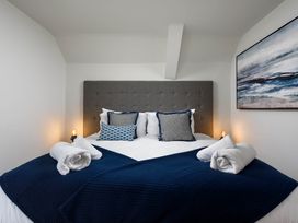 A bedroom with a bed and pillows at Whalesborough Cottage Spa in Marhamchurch