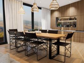 A dining room with a table and chairs at Kew Villa (Pet) in Marhamchurch