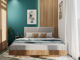 A bedroom with a bed, bedside table, and wall art at Kew Villa (Pet) in Marhamchurch